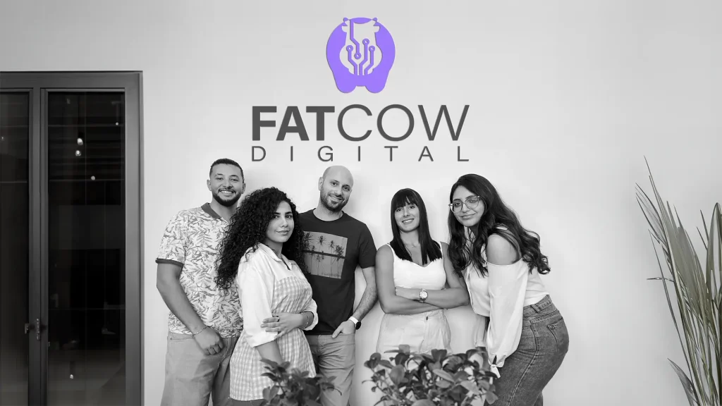 Original Team of Fatcow Digital with company logo on wall behind them