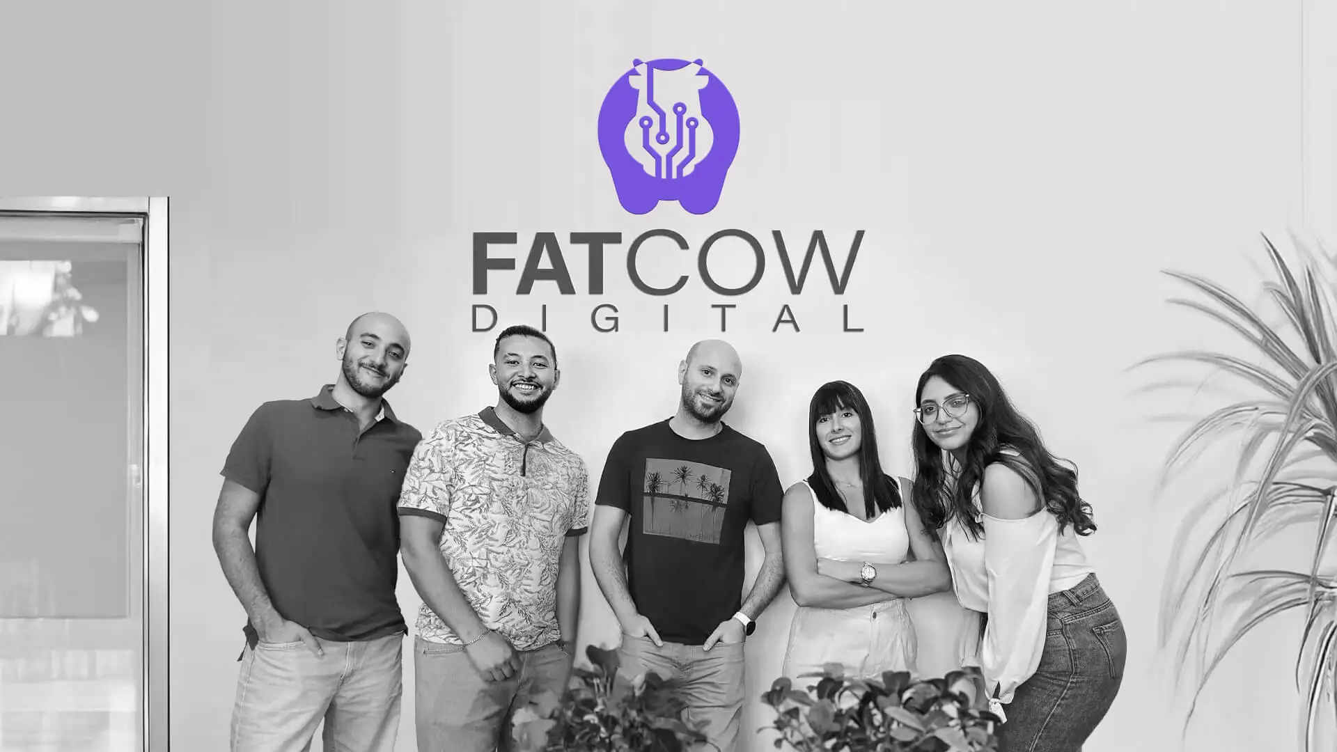 Original Team of Fatcow Digital with company logo on wall behind them